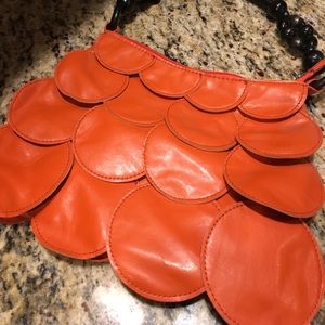 Orange scalloped purse.
